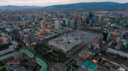 Evening lights in Ulaanbaatar's orderly city center mountains backdrop