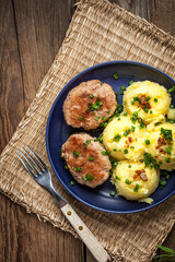 Meatballs served with boiled potatoes.