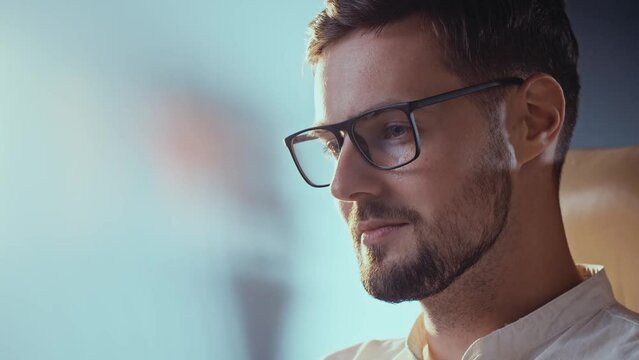 Hr manager guy browsing social media. Confident recruiter man reviewing cv of potential candidates. Slow motion work in progress. Adult businessman thinking and smiling