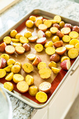 Roasting Halved Mixed Marble Potatoes in Modern Kitchen