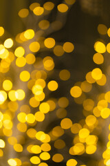 Christmas golden glowing background. Golden festive abstract shiny defocused background with...