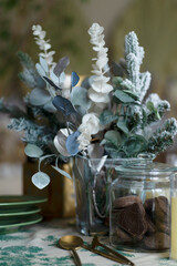 A bouquet of Christmas trees decorates the table, close-up