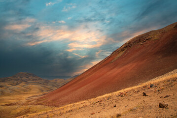 Fototapeta na wymiar Dramatic sunset in the volcanic mountains. 