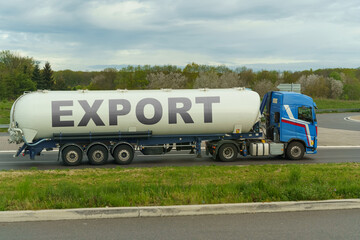 On a tank truck driving along the road there is an inscription - export