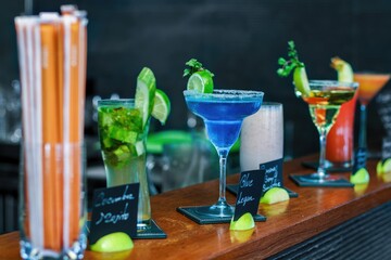 Sparkling Blue Lagoon cocktail with Spicy wine cocktail in a glass, cucumber mojito, and banana...
