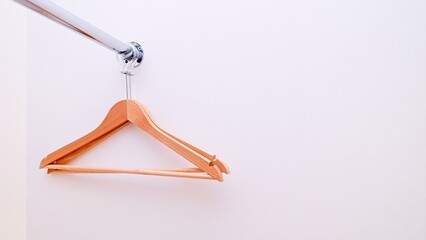 Two empty clothes hangers in the closet.