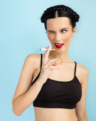 Young woman lighting a cigarette, getting her nicotine daily dose, unable to resist to her unhealthy habit