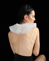 Rear view at topless brunette caucasian model in black underwear on dark background