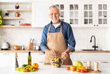 Portrait Of Handsome Mature Chef Man In Apron Posing In Kitchen Interior