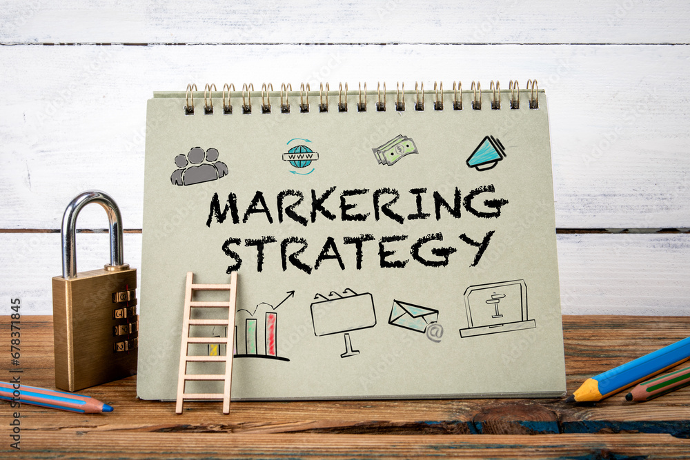 Canvas Prints marketing strategy. green notepad on wooden texture table and white background