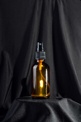 Single brown spray bottle for mock up on black background close up. Sustainability and eco friendly...