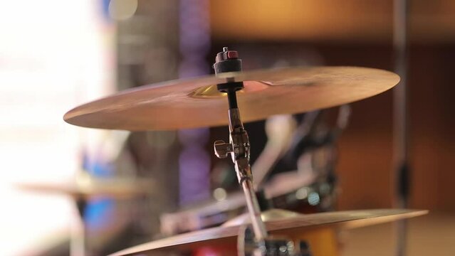 musical cymbal closeup shot. musical cymbal on a blurred background, bokeh. drum set as musical background. Drum set, drum kit, musical cymbal. musical cymbal as musical background.