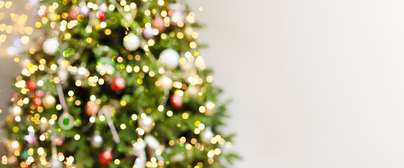 Defocus blurred background with elegant fir, garlands, highlights. Beautiful festive Christmas...