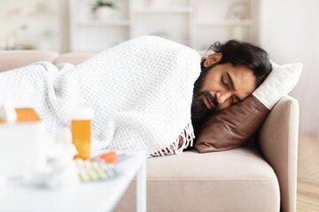 Sick Indian Guy Having Fever Lying On Couch At Home