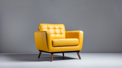 Yellow button tufted soft cushioned leather armchair on gray background. Interior design modern...
