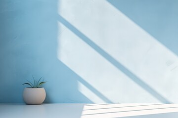 Minimal light blue background for product presentation. Shadow and light from windows on wall.