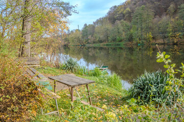 Quiet bench at Park by river Berunka Fall Autumn Trees. Autumn morning light