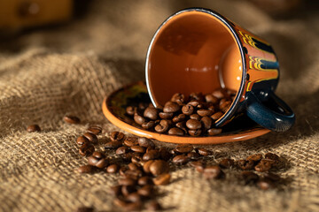 Ceramic coffee cup and coffee beans on the table