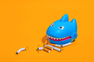 Shark toy with cigarette butts