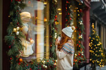 Woman enjoying Christmas window display in Quebec, Canada