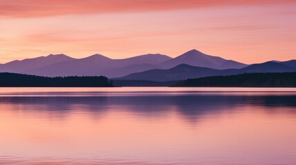 Fototapeta premium Sunset over mountains with lake and background mountains.