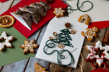 Concept of christmas holiday craft with new year fir tree embroidering with wooden thread, handmade...