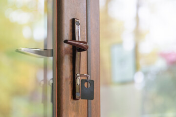 Key with key fob in the keyhole of a closed door