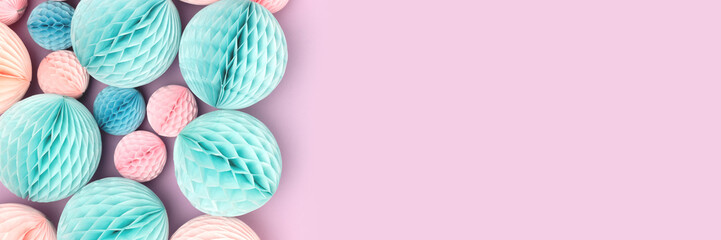 Banner with tissue paper balls on a purple background. Creative concept.