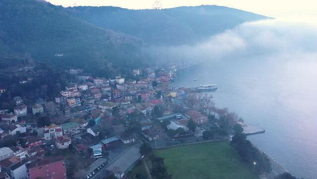 Istanbul, Anadolu Kavağı resort town in dense fog. A mist bank covered the whole Bosphorus like a cotton quilt. Aerial drone view
