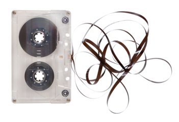 Old cassette tape unrolled on an isolated background.