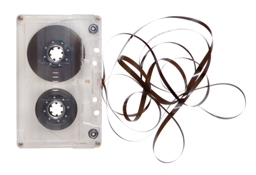 Old cassette tape unrolled on an isolated background.