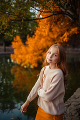 beautiful teenage girl on a walk in the autumn park