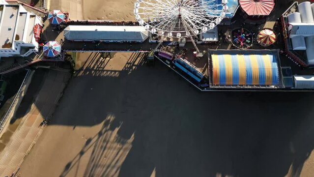 Aerial video of the ferry's wheel and pier in Blackpool during the sunny day