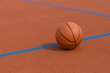 New orange basketball with blue line on orange court of gymnasium sport floor. Horizontal sport theme poster, greeting cards, headers, website and app
