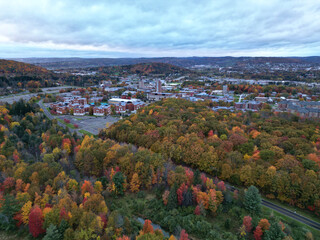 arial view of binghamton university in vestal, new york during autumn with fall foliage (leaves...