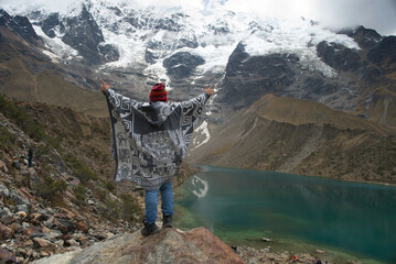 Cusco, Peru - September 15, 2023: A triumphant moment by Laguna Humantay, with the snow-capped...