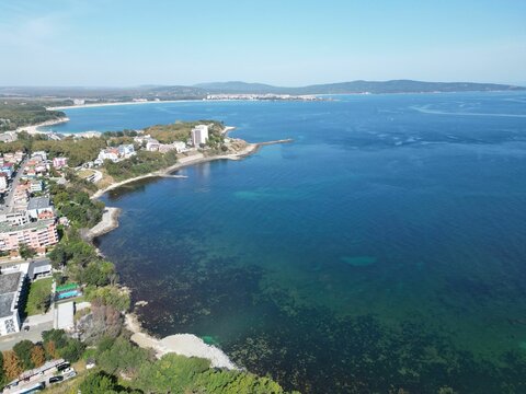 Aerial shot of the coastal town of Primorsko with resort buildings under the blue sky
