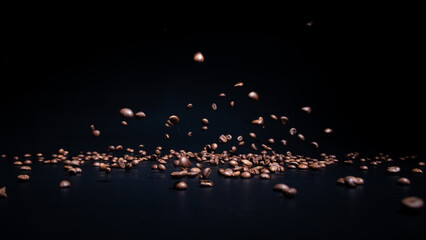 Roasted coffee beans on a black background in the process of falling