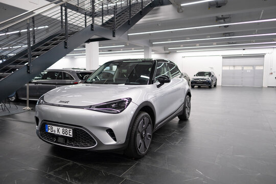 new white electric SUV Smart Hashtag One in showroom, trends EV contemporary Europe, technological advancements in automotive industry, environmental cleanliness vehicle, Frankfurt - November 9, 2023