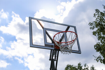 basketball hoop stands tall against a sunset sky, inviting play and capturing the essence of active sports and healthy living."

50 key words about the meaning and symbolism of basketball
