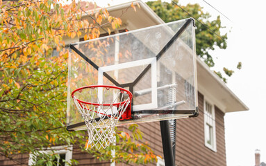 basketball hoop stands tall against a sunset sky, inviting play and capturing the essence of active...