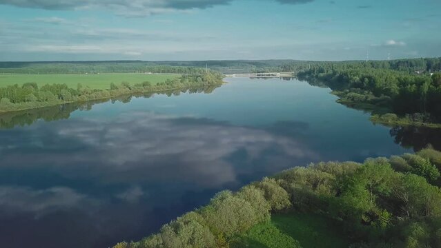 A beautiful cinematic frame of nature. A picture of a small river among fields