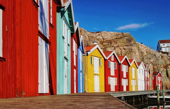 Scenic view of the colorful wooden boathouses lined in the wooden long boardwalk in Smogen, Sweden