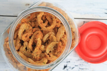 Indonesian snack fried tofu with spicy seasoning in a jar on the table