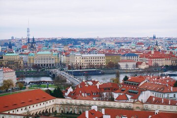 Fototapeta na wymiar Drone shot of a cityscape with river under gray sky