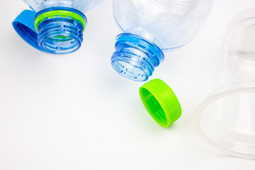 Plastic bottles on a white background. Recyclable plastic waste with space for copying text, with space for text. Empty plastic water bottles. Plastic containers, dishes, food.