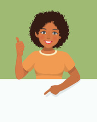 Young African woman standing behind blank board showing thumb up pointing finger to empty banner for copyspace advertising