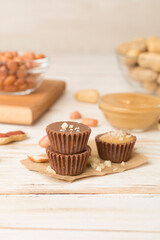 Tasty chocolate peanut butter cups on wooden table