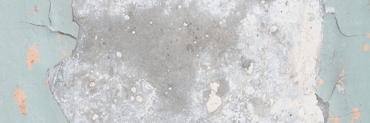 Peeling paint on the wall. Old concrete wall with cracked flaking paint. Weathered rough painted surface with patterns of cracks and peeling. Grunge texture for background and design. High resolution.
