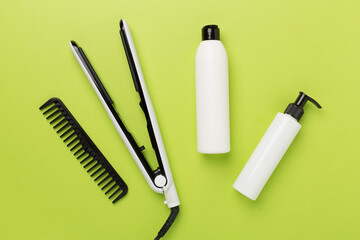 Hair straightener with thermo protection on color background, top, view